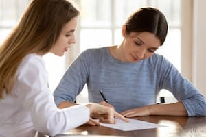 Woman with nurse looking at insurance