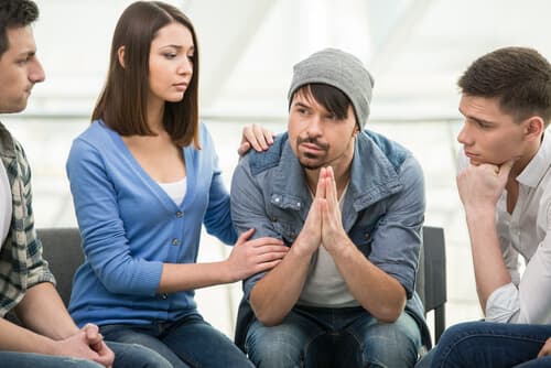 Man in group therapy trying to get the most benefits out of it for his addiction