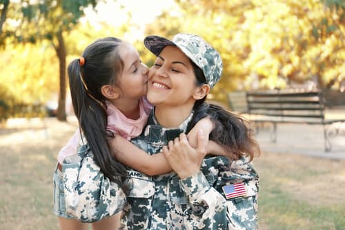 a child greets her mother upon completion of military deployment