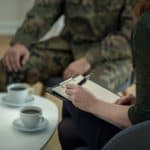 a therapist reviews a veterans symptoms of mental health disorder