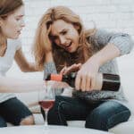 women drinking too much wine