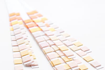 Many test strips for semiquantitative analysis on white background