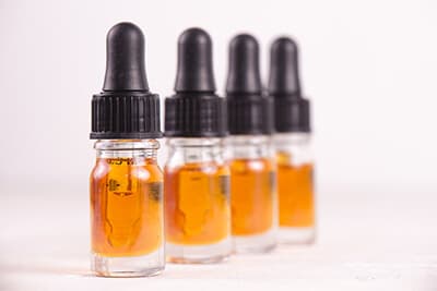 Macro detail of dropper with CBD oil, cannabis live resin extraction isolated on white