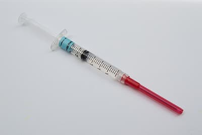 Syringe with Narcotic Painkiller, Fentanyl, against White Background